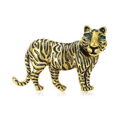 Gold tone standing tiger brooch with black stripes and teal crystal eyes
