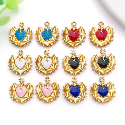 Gold-tone heart charms arranged on a light background