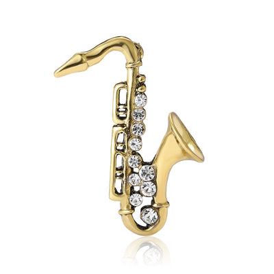 Front view of the crystal saxophone brooch in antique gold and silver brooch and its color options