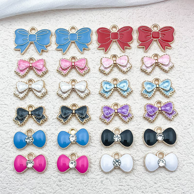 Colorful bow and butterfly charms arranged on a light background