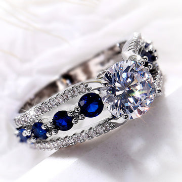 Round Clear Solitaire Split Band Ring With Blue Side Stones