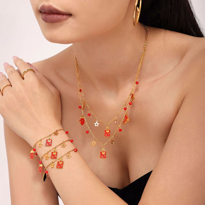 Coordinated set view of garnet Christmas charm necklace and bracelet in main image 1.