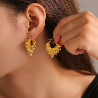 Model ear gold leaf cluster hoop earring hand holding matching hoop