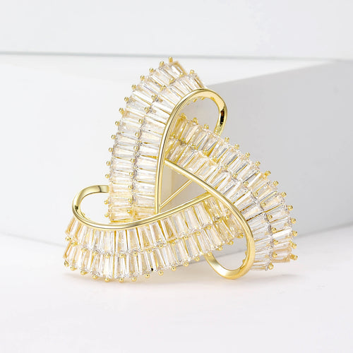 Three interlocking curved geometric loops set with crystals shown in a styled display.