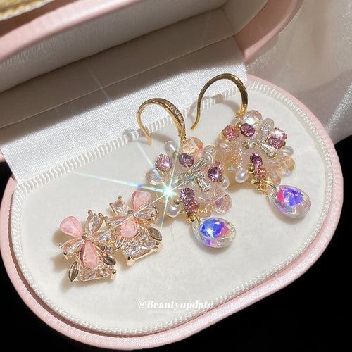 Pink petal clusters with iridescent faceted crystal drops in a close product view.