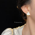 White Enamel Flower Stud Earrings Gold Leaf Accent Pair view 2