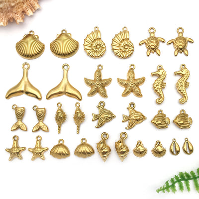 Gold-tone seashell charms arranged on a light background