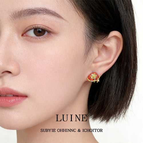 Orange enamel persimmon stud worn on ear side profile