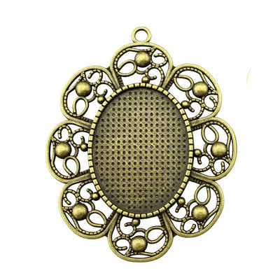Ornate Scroll Oval Cabochon Pendant Trays in Two Finishes shown in image 1 with a broad symmetrical scrollwork frame