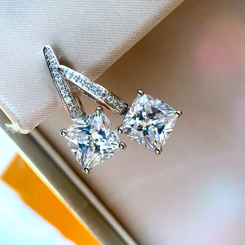 Alternate display view of silver tone square crystal curved drop earrings polished metal jewelry