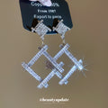 Silver Tone Crystal Open Diamond Drop Earrings with Polished Metal Details view 2