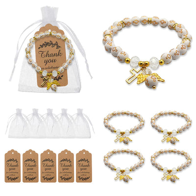 A white cross bead bracelet is shown with a white drawstring pouch, brown thank-you tags, and grouped bracelet units.