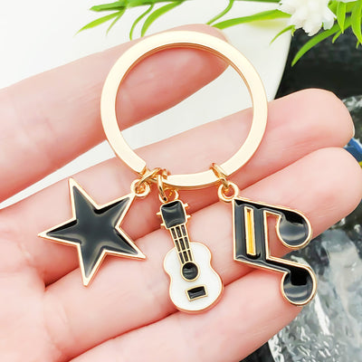 Overview showing the available color and design variations of the guitar keyboard and headphone metal keychain