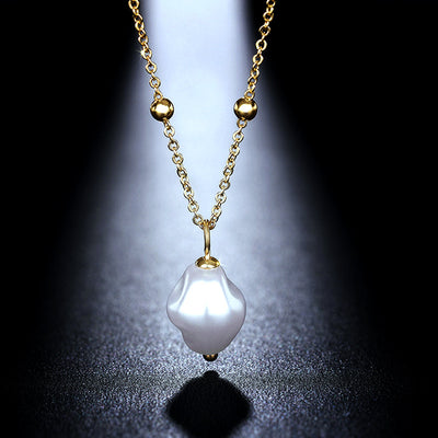 Gold irregular baroque pearl pendant satellite necklace on black spotlight