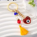 Gold Tone Red Evil Eye Heart Bead and Tassel Keychains view 2