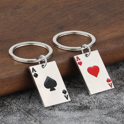 Two silver-tone key rings display rectangular ace tags with black spade and red heart designs.