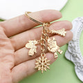 Christmas Charm Keychains Featuring Gold Santa Across 41 Pictured Variations view 2