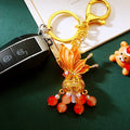 Illuminated Orange Plume Keychain With Pearl and Bead Tassels view 3