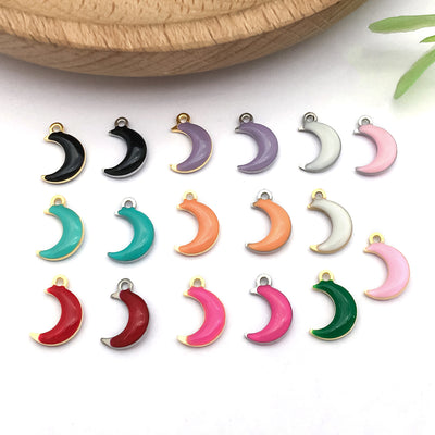 Gold-tone moon charms arranged on a light background