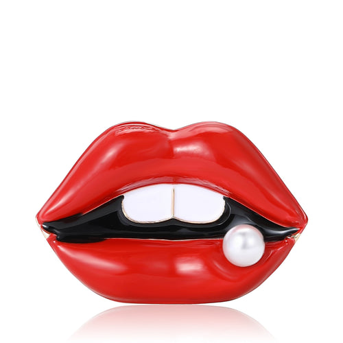 Red enamel lips brooch with white teeth and pearl on reflective white
