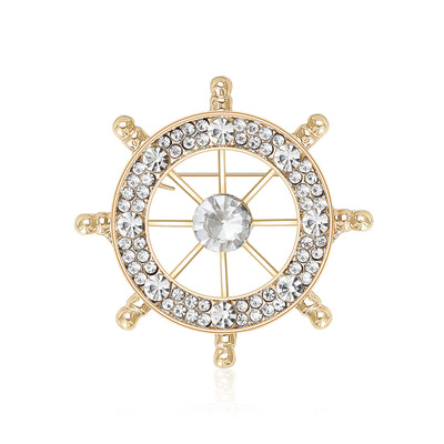 An open ship wheel outlined with clear crystals shown on a white background.