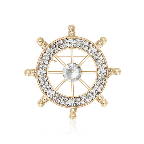 An open ship wheel outlined with clear crystals shown on a white background.