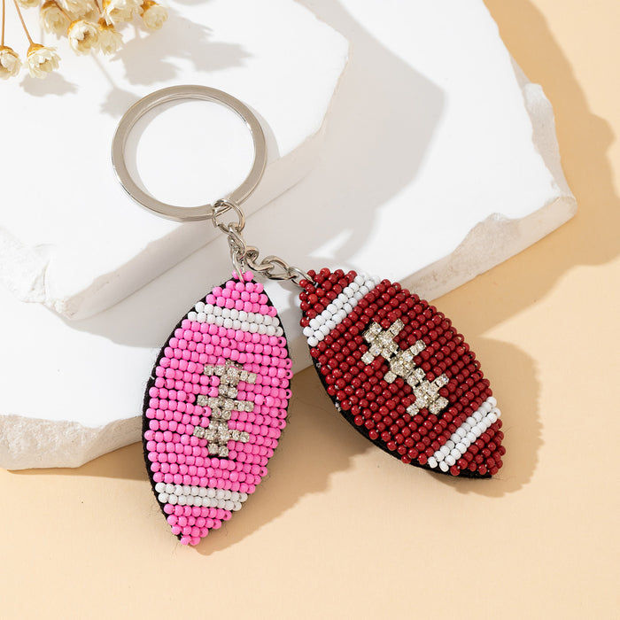 Pink And Burgundy Beaded Football Charm Keychain With Rhinestone Accents