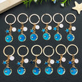 Six Blue Zodiac Moon and Star Metal Keychain Designs view 1
