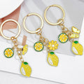 Gold-Tone Enamel Lemon Keychain With Citrus Slice Flower And Butterfly Charms view 1