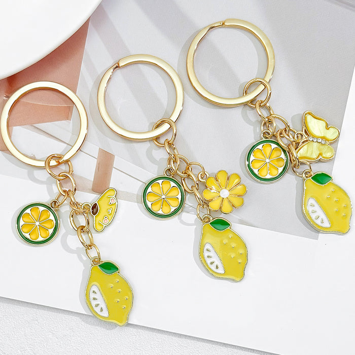 Gold-Tone Enamel Lemon Keychain With Citrus Slice Flower And Butterfly Charms