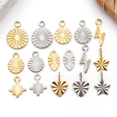 Gold-tone heart and star charms arranged on a light background