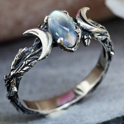 Product view showing antiqued silver-tone opalescent oval moon phase ring