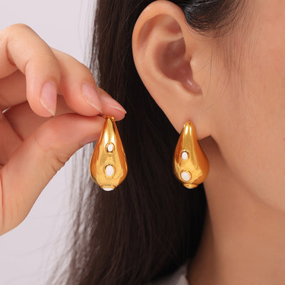 Model wearing gold white oil drip teardrop stud earrings