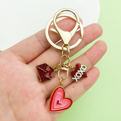 Image 1 showing a person holding two different key chains.