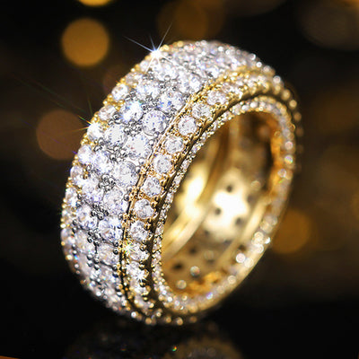 Two-tone gold and silver full pave eternity band ring on reflective black surface