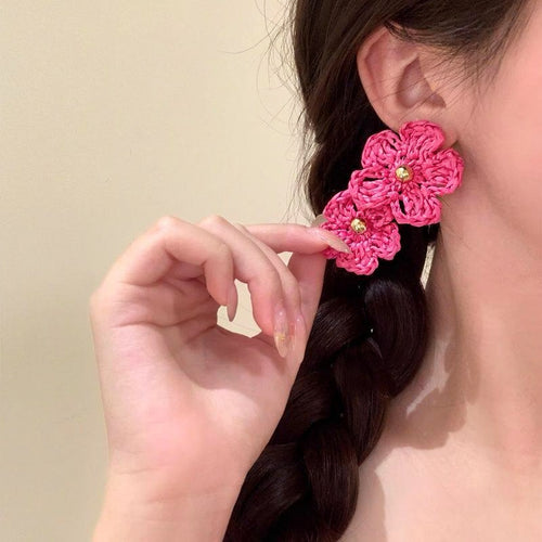Close display of the crochet triple flower statement earrings fashion jewelry accessory