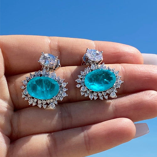 Aqua Blue Oval Halo Stone Drop Earrings in Silver Tone shown in alternate angle