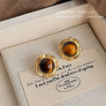 Gold Tone Round Stud Earrings Brown Tiger Eye Center view 1