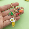 Gold-Tone Fruit And Drink Charm Keychain With Palm Tree And Cherries view 1