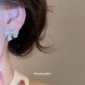 Crystal Bow Stud Earrings in Silver and Gold with Polished Metal Details view 3