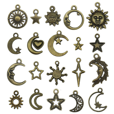 Gold-tone sun and moon charms arranged on a light background