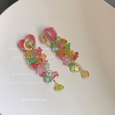 Pink heart clip-on tassel earrings showing spiral clip backs