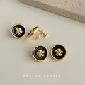 Black Enamel Gold Camellia Round Clip Stud Earrings view 1