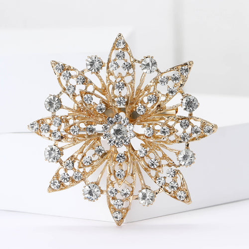 Gold crystal starburst flower brooch front close-up