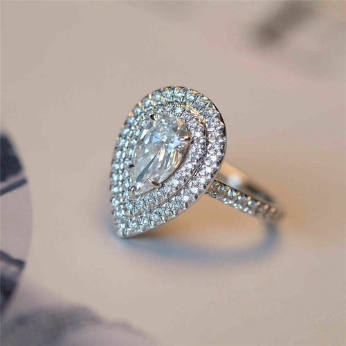Pear double halo ring angled close-up showing claw set center