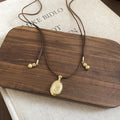 Textured Oval Pendant Necklace On Brown Cord Jewelry Design view 6