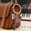 Purple Black Red Blue Pink and Yellow Music Keychains view 1