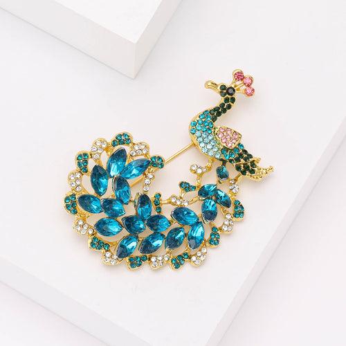 Close-up product view showing the colors and surface details of the blue crystal peacock brooch