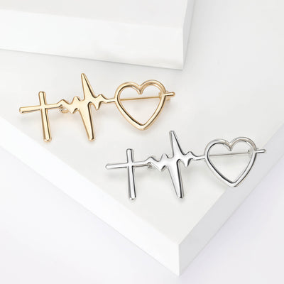 Gold and silver heartbeat line brooches on white steps