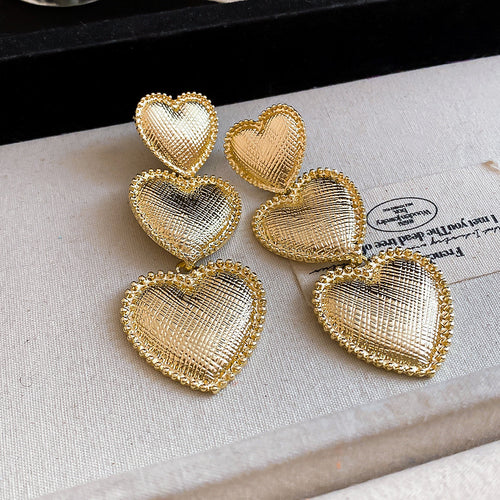 Three graduated open hearts with finely textured borders shown in a styled front view.